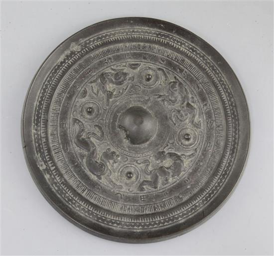 A Chinese bronze circular mirror, Han dynasty, 2nd century B.C.- 2nd century A.D., 18cm diameter